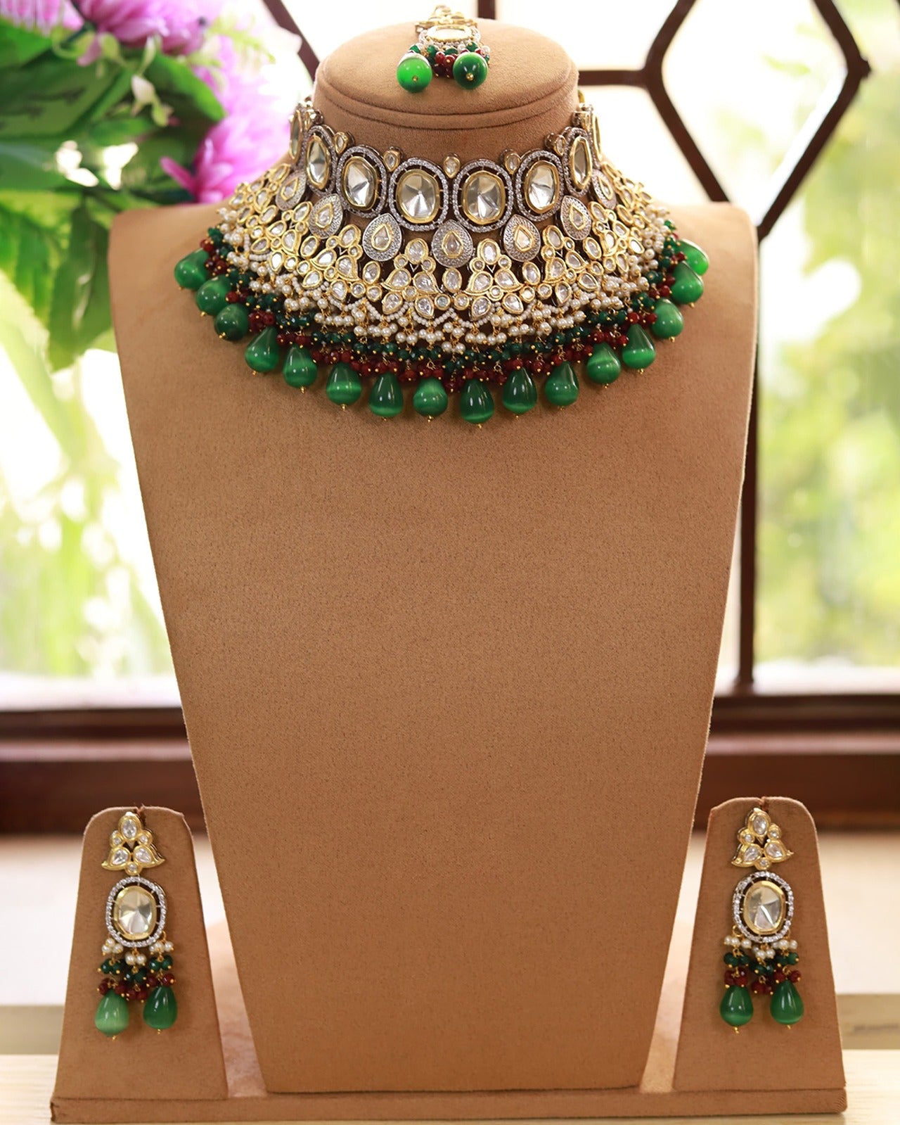A bridal polki necklace set, featuring a green and gold necklace with intricate floral-inspired designs for phera wedding jewellery