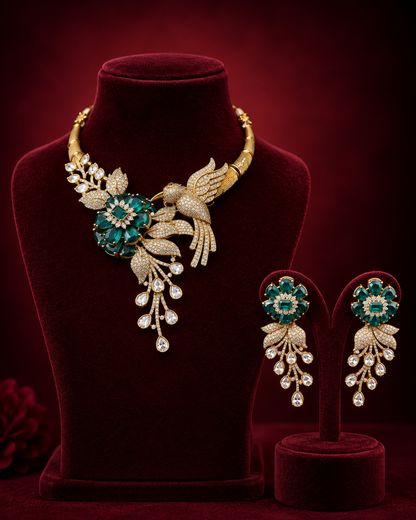 The Emerald Floral Bird Statement Necklace Set features detailed craftsmanship combining floral and avian motifs with emerald-toned elements, offering a visually striking accessory that enhances formal attire through its balanced design and color contrast.