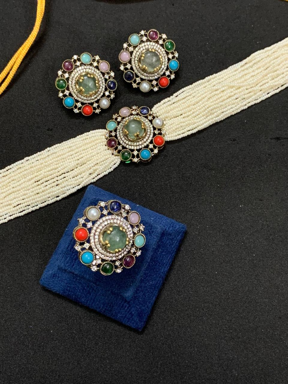 Multicolor choker necklace set featuring vibrant gemstones and intricate detailing, paired with a matching statement ring.
